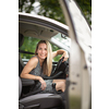 Pretty midle aged woman at the steering wheel of her car