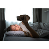 Pretty, young woman sleeping in her bed with her cell phone close to her. Smartphone in Bed Mobile/smartphone  Addiction Concept.