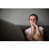 Depressed mid-aged woman at home feeling sad, lonely, anxious (color toned image)