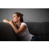Depressed mid-aged woman at home feeling sad, lonely, anxious (color toned image)