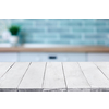 Empty perspective, white wooden boards or table top against blurred kitchen interior on background. May be used as template and mockup for display or montage of your products. Close up, copy space