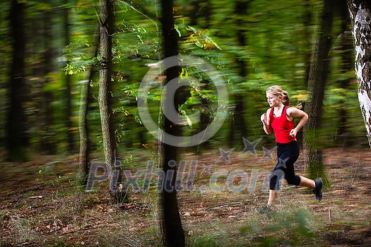 Pretty. young woman running fast in a forest - motion blur technique used to convey speed and movement Pretty. young woman running fast in a forest - motion blur technique used to convey speed and movement