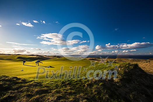 Golfers on a lovely golf course in St. Andrews, Scotland Golfers on a lovely golf course in St. Andrews, Scotland