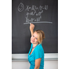 Pretty young college student or teacher washing the chalkboard/blackboa rd during class (shallow DOF; color toned image)