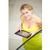Cute, femle student using a tablet computer in a library/on uni campus