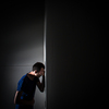 Young man suffering from severe belly pain, being cornered by the debilitating condition of celiak disease/Crohn's disease/autoimune disease