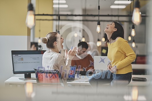 office rumors with two girls whispering in coworking open space startup business office office rumors with two girls whispering in coworking open space startup business office