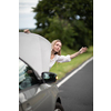 Pretty middle aged woman having car troubles - broken down car on the side of the road, calling the insurance company for assistance