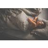 Pretty, middle-aged woman using her tablet computer before sleep in bed in the evening