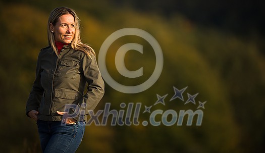 Portrait of a pretty middle-aged woman outside in a park, portrait with lots of copy space Portrait of a pretty middle-aged woman outside in a park, portrait with lots of copy space