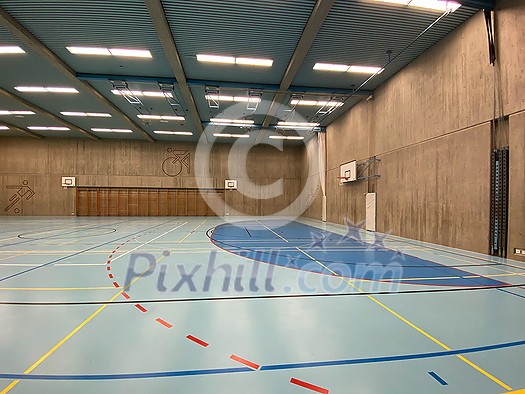 Interior of empty modern gymnasium - basketball, floorball, badminton, velleyball, soccer indoor sport courts Interior of empty modern gymnasium - basketball, floorball, badminton, velleyball, soccer indoor sport courts