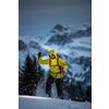 Young man snowshoeing in high mountains, enjoying splendid winter weather with abundance of snow