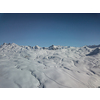 Snow covered winter sports resort in Swiss Alps - aerial image