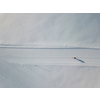 Cross-country skiing: young woman cross-country skiing on a winter day (motion blurred image) - aerial image