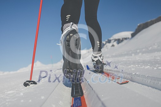 Cross-country skiing: young woman cross-country skiing on a winter day (motion blurred image) Cross-country skiing: young woman cross-country skiing on a winter day (motion blurred image)
