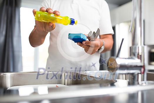Senior man washing dishes in his modern, bright kitchen Senior man washing dishes in his modern, bright kitchen