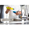 Senior man washing dishes in his modern, bright kitchen