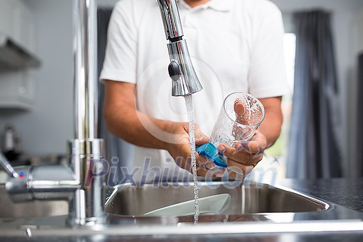 Senior man washing dishes in his modern, bright kitchen (shallow DOF; color toned image) Senior man washing dishes in his modern, bright kitchen (shallow DOF; color toned image)