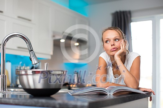 Pretty, young woman in her modern, clean and bright kitchen, fixing lunch (color toned imagey; shallow DOF) Pretty, young woman in her modern, clean and bright kitchen, fixing lunch (color toned imagey; shallow DOF)