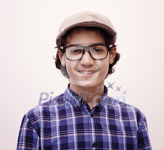 portrait of smart looking arab teenager with glasses wearing a hat in casual school look isolated on white copy space portrait of smart looking arab teenager with glasses wearing a hat in casual school look isolated on white copy space