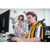business couple working together on project using tablet and desktop computer at modern open plan startup office