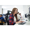 casual business woman working on desktop computer in modern open plan startup office interior