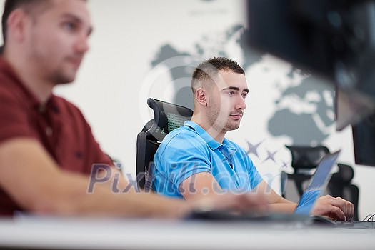 startup business, two male software developers working on computer at new modern open plan office startup business, two male software developers working on computer at new modern open plan office