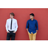 portrait of casual multiethnic startup business men one of them is indian during break from work in front of pink wall outside