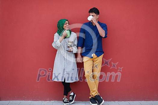 multiethnic group of casual business people using mobile phone during coffee break from work in front of pink wall outside multiethnic group of casual business people using mobile phone during coffee break from work in front of pink wall outside