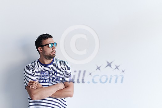 portrait of casual startup businessman with crossed arms wearing a T-shirt and sunglasses isolated on white background portrait of casual startup businessman with crossed arms wearing a T-shirt and sunglasses isolated on white background