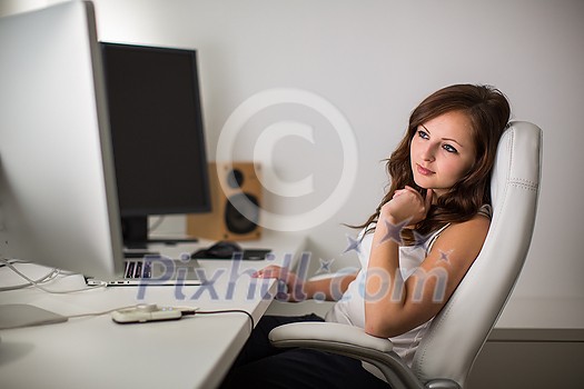Woman working on a computer in a home office Woman working on a computer in a home office