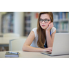 Pretty, female college student in a library, looking for a book (shallow DOF; color toned image)