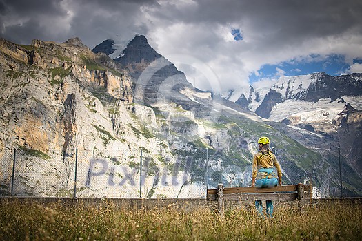 Pretty, female climber on a via ferrata - climbing on a rock in Swiss Alps Pretty, female climber on a via ferrata - climbing on a rock in Swiss Alps
