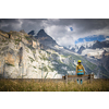 Pretty, female climber on a via ferrata - climbing on a rock in Swiss Alps
