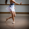 Legs and slippers of classical ballet dancers rehearsing