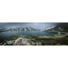 Young admiring the natural beauty of a glaciar lake in Swiss Alps - Panoramic image