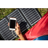 Cell phone charging with a solar charger in a tent during an outdoor trip