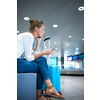Young woman with her luggage at an international airport, before going through the check-in and the security check before her flight