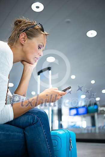Young woman with her luggage at an international airport, before going through the check-in and the security check before her flight Young woman with her luggage at an international airport, before going through the check-in and the security check before her flight