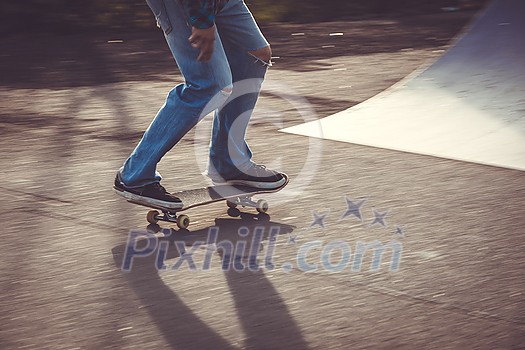 Skateboarder riding fast towards the ramps to be lifted into the air and perform a trick Skateboarder riding fast towards the ramps to be lifted into the air and perform a trick
