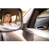 Pretty, young woman  driving a car.  Invitation to travel. Car rental or vacation.