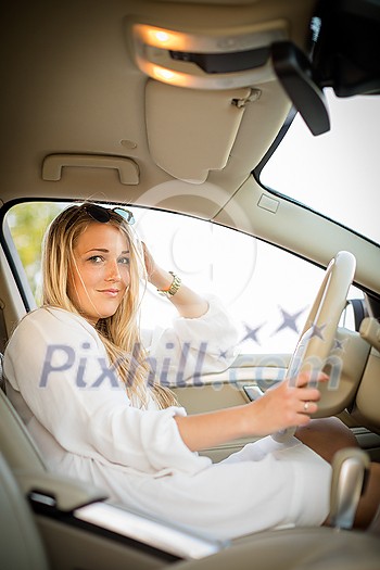 Pretty, young woman driving a car -Invitation to travel. Car rental or vacation. Pretty, young woman driving a car -Invitation to travel. Car rental or vacation.