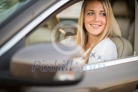 Pretty, young woman driving a car -Invitation to travel. Car rental or vacation. Pretty, young woman driving a car -Invitation to travel. Car rental or vacation.