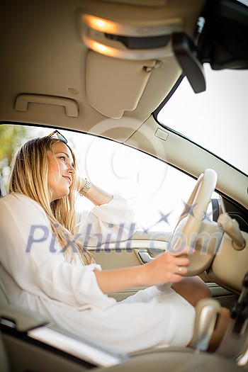 Pretty, young woman driving a car -Invitation to travel. Car rental or vacation. Pretty, young woman driving a car -Invitation to travel. Car rental or vacation.