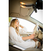 Pretty, young woman  driving a car -Invitation to travel. Car rental or vacation.