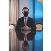 corporate business man wearing protective medical face mask at luxury office