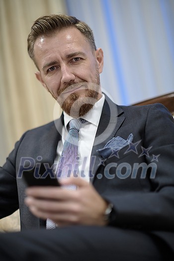 Senior executive businessman at luxury corporate workspace. Portrait of smiling ceo at modern office in stylish suit Senior executive businessman at luxury corporate workspace. Portrait of smiling ceo at modern office in stylish suit