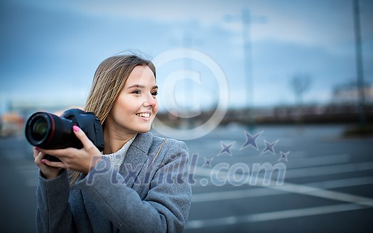 Pretty, young woman taking photos with her professional dslr camera Pretty, young woman taking photos with her professional dslr camera