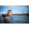 Pretty, young woman taking photos with her professional dslr camera