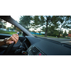 Hands of a driver on a wheel of a car (motion blurred image)